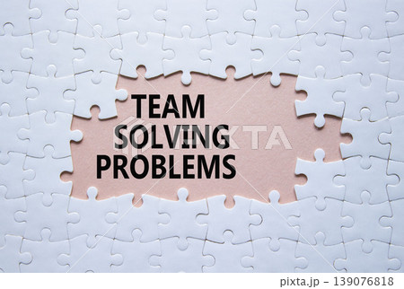 Team Solving Problems symbol. White puzzle with words Team Solving Problems. Beautiful pink background. Business concept. Copy space. Team Solving Problems symbol. White puzzle with words Team Solving Problems. Beautiful pink background. Business concept. Copy space. 139076818