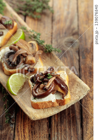 Sandwiches with baked mushrooms on an old wooden table. 139076840