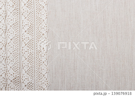 Lace ribbon on linen cloth background 139076918
