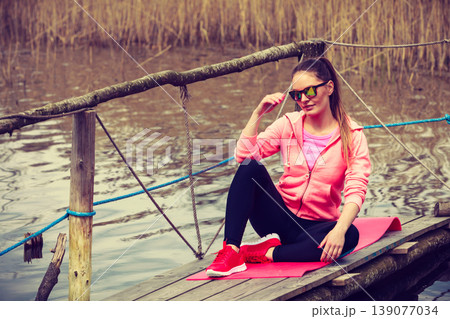 Young sports woman taking break after a run. Young sports woman taking break after a run. 139077034
