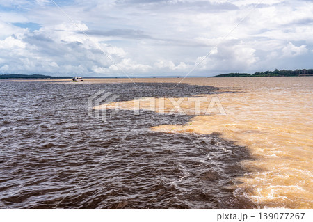 Meeting of the waters of the Negro and Solimoes rivers in the city of Manaus in Amazonia, Brazil 139077267