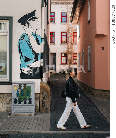 Woman Walking Through Narrow Historic Alley by Street Art Woman Walking Through Narrow Historic Alley by Street Art 139077529