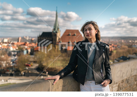 Stylish Woman at Scenic Viewpoint Above Historic European City Stylish Woman at Scenic Viewpoint Above Historic European City 139077531