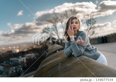 Young Woman Leaning on Stone Railing at Scenic City Viewpoint Young Woman Leaning on Stone Railing at Scenic City Viewpoint 139077534