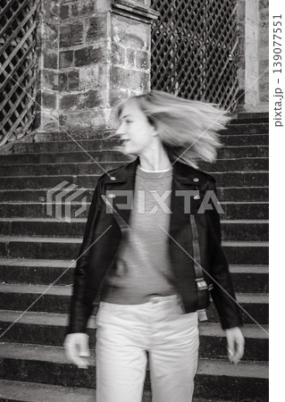 Black and White Motion Portrait of Woman on Stone Stairs 139077551