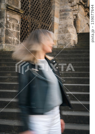 Blurred Woman Turning on Stone Stairs Near Historic Cathedral 139077644