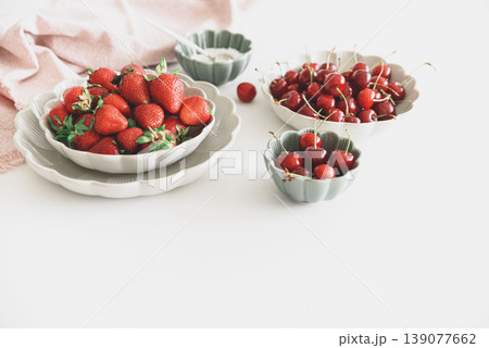 Strawberries and Red Cherries with Sugar Bowl on White Table 139077662
