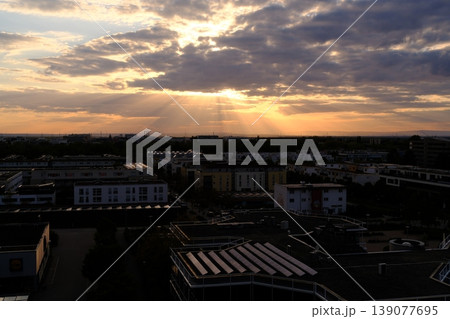 beautifull sunset view of the city through the clouds beautifull sunset view of the city through the clouds 139077695