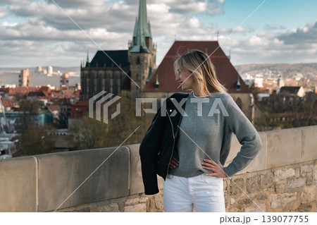 Woman Looking Aside at Historic European City Viewpoint Woman Looking Aside at Historic European City Viewpoint 139077755