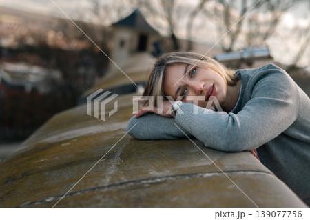 Woman Resting on Stone Wall in Soft Outdoor Portrait Woman Resting on Stone Wall in Soft Outdoor Portrait 139077756