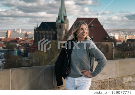 Smiling Woman at Historic European Viewpoint with City Skyline 139077775