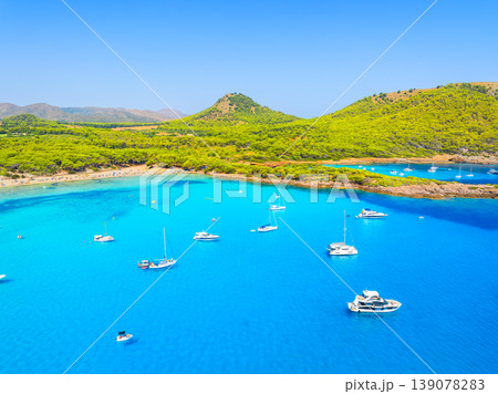 Aerial view of Cala Agulla beach and turquoise bay with boats in Mallorca.  139078283