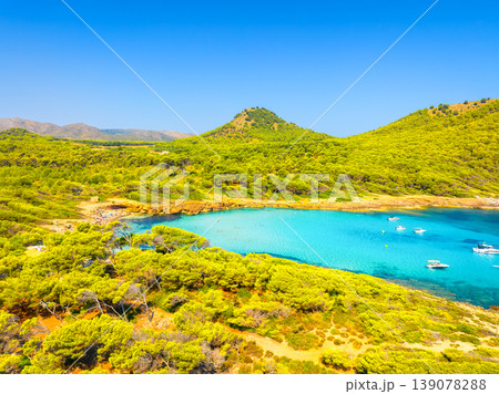 Aerial view of Cala Agulla beach and turquoise bay with boats in Mallorca. Aerial view of Cala Agulla beach and turquoise bay with boats in Mallorca. 139078288