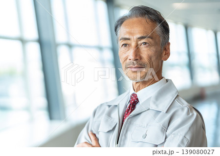 腕組みをする作業着の男性 腕組みをする作業着の男性 139080027