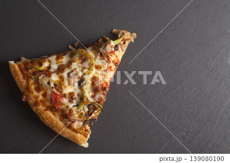 Slice of Mixed Pizza on Granite Surface Slice of Mixed Pizza on Granite Surface 139080190