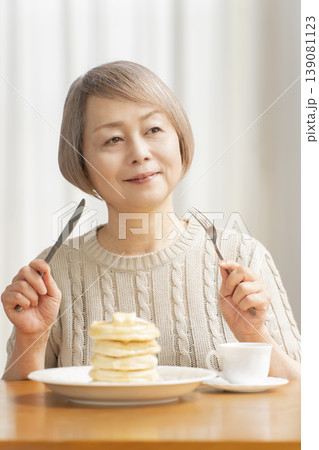 ダイニングでパンケーキを食べるシニア女性　 139081123