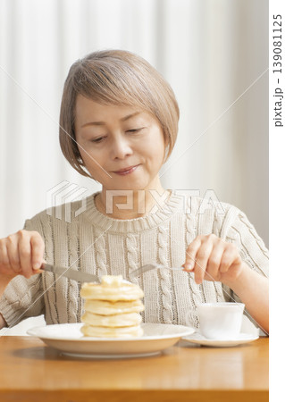 ダイニングでパンケーキを食べるシニア女性　 139081125