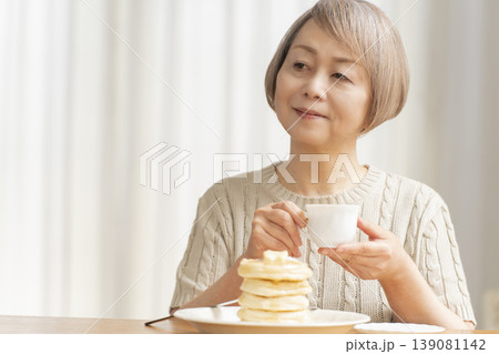 ダイニングでパンケーキを食べるシニア女性 ダイニングでパンケーキを食べるシニア女性 139081142