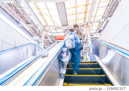 エスカレーターでホームへ上がるリュックの女性 高円寺駅 東京 エスカレーターでホームへ上がるリュックの女性 高円寺駅 東京 139082327