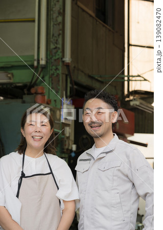 製造業などの町工場で働く夫婦の笑顔で未来や希望を見つめる(見上げる)　中小企業の家族経営とものづくり 139082470