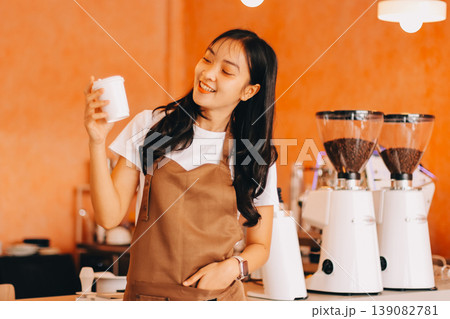 Young woman at barista school learning how to make espresso coffee. Young woman at barista school learning how to make espresso coffee. 139082781