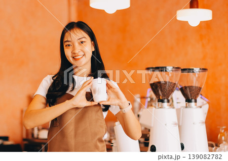 Young woman at barista school learning how to make espresso coffee. Young woman at barista school learning how to make espresso coffee. 139082782