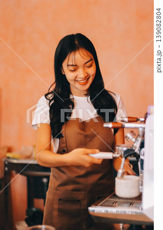 Young woman at barista school learning how to make espresso coffee. 139082804
