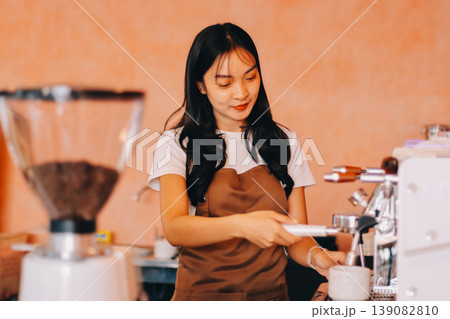 Young woman at barista school learning how to make espresso coffee. 139082810