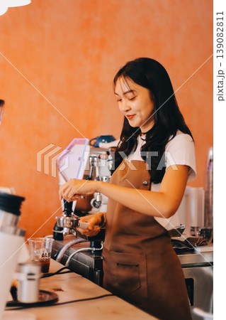 Young woman at barista school learning how to make espresso coffee. Young woman at barista school learning how to make espresso coffee. 139082811