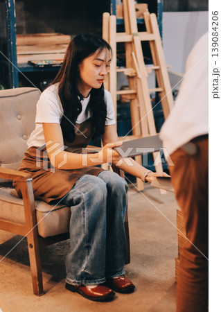 Female artist wears black hat posing near picture indoor the studio 139084206