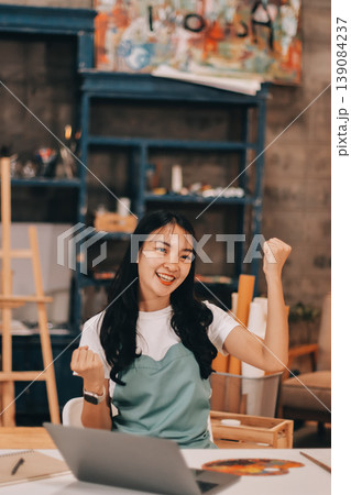 Female artist wears black hat posing near picture indoor the studio Female artist wears black hat posing near picture indoor the studio 139084237