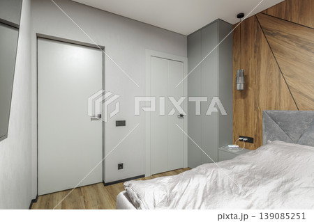 Closed Bifold Door in Modern Grey Bedroom Interior Closed Bifold Door in Modern Grey Bedroom Interior 139085251