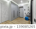 Modern Minimalist Hallway Interior with Grey Wardrobe and Blue Ottoman 139085265