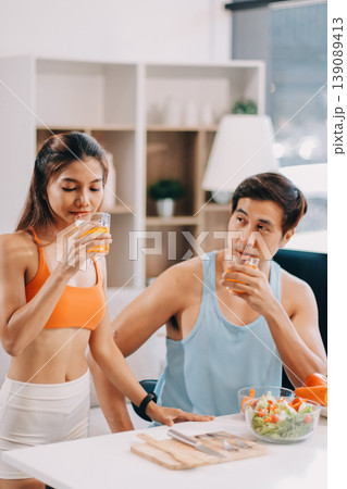 A happy couple prepares fresh vegetables, laughing and enjoying cooking a healthy meal together. A happy couple prepares fresh vegetables, laughing and enjoying cooking a healthy meal together. 139089413