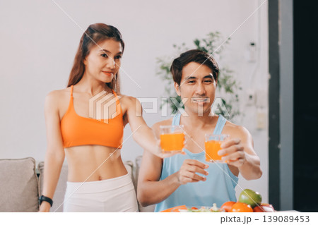 A happy couple prepares fresh vegetables, laughing and enjoying cooking a healthy meal together. A happy couple prepares fresh vegetables, laughing and enjoying cooking a healthy meal together. 139089453