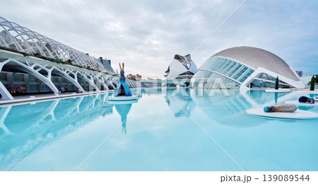 VALENCIA, SPAIN - OCTOBER 17, 2021: Panoramic view of the city of arts and sciences in Valencia created by architect Santiago Calatrava, overlooking Hemisferic and Queen Sofia Palace of the Arts VALENCIA, SPAIN - OCTOBER 17, 2021: Panoramic view of the city of arts and sciences in Valencia created by architect Santiago Calatrava, overlooking Hemisferic and Queen Sofia Palace of the Arts 139089544