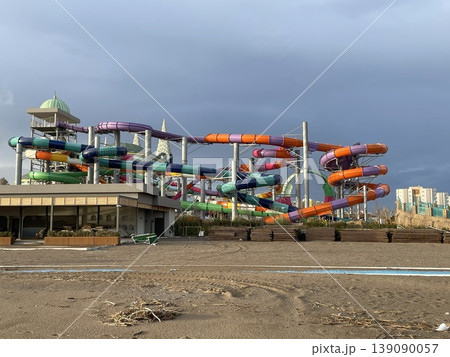 Waterpark slides and structures under a cloudy sky, outdoor amusement attraction Waterpark slides and structures under a cloudy sky, outdoor amusement attraction 139090057