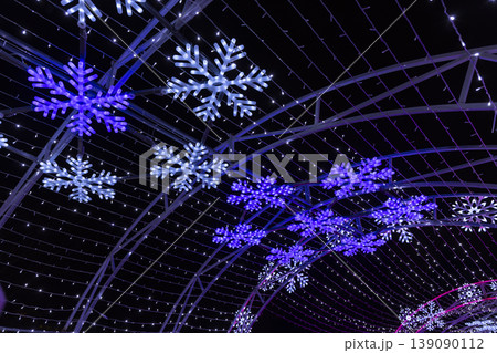 Illuminated snowflake light tunnel decorating winter holidays at night 139090112