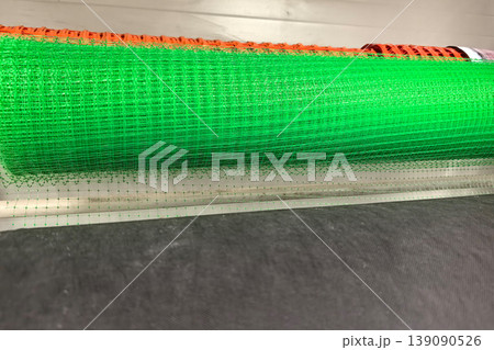 Bright green mesh rolls stacked for construction and safety projects 139090526