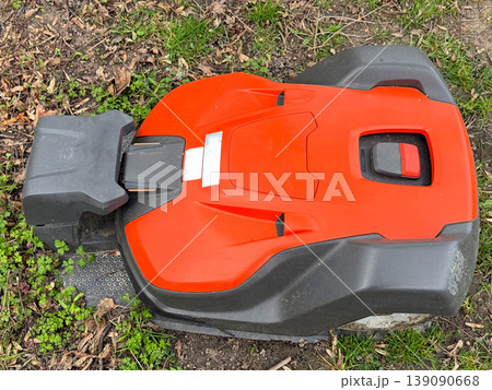 Robotic lawn mower on grass in garden. 139090668
