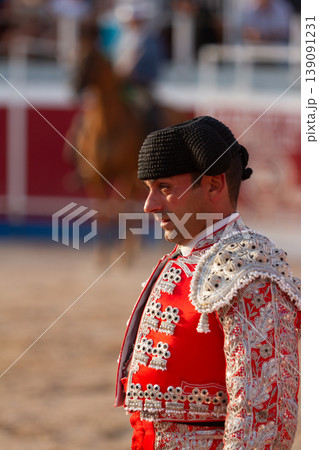 A bullfighter tensely watches the bull during a bullfight. A bullfighter tensely watches the bull during a bullfight. 139091231
