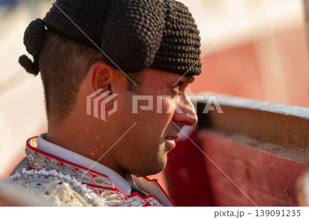 A bullfighter looking on with tension from the burladero 139091235