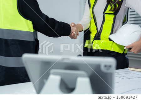 construction worker and contractor. Client shaking hands with team builder in renovation site in the morning. 139091427