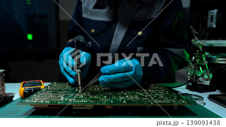 Hands repairing electronic devices. Electronic technician. Hands repairing electronic devices. Electronic technician. 139091438