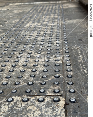 Tactile paving on urban street for visually impaired pedestrian navigation background and texture 139092024