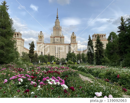 Main building of moscow state university surrounded by colorful flower garden on a clear day Main building of moscow state university surrounded by colorful flower garden on a clear day 139092063