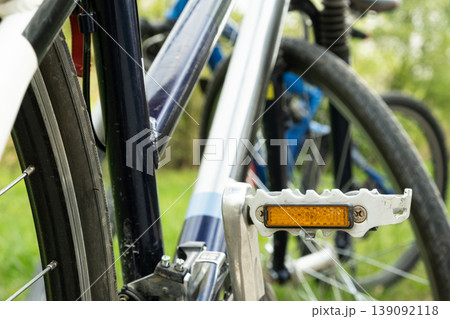 Close-up of an orange safety reflector on a bicycle pedal. 139092118