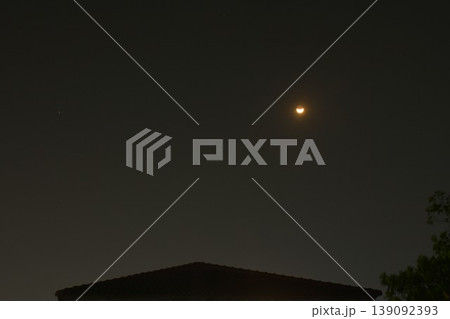 yellow half moon floating over rooftop home building on sky in night background yellow half moon floating over rooftop home building on sky in night background 139092393