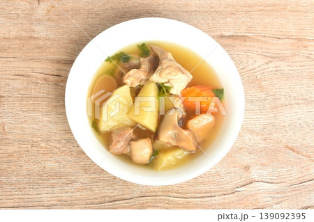 boiled pineapple with pork bone and carrot couple pickled radish topping black mushroom soup on bowl boiled pineapple with pork bone and carrot couple pickled radish topping black mushroom soup on bowl 139092395