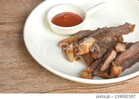 fried crispy salty fermenting beef fat meat with pepper on plate dipping spicy chili sauce 139092397